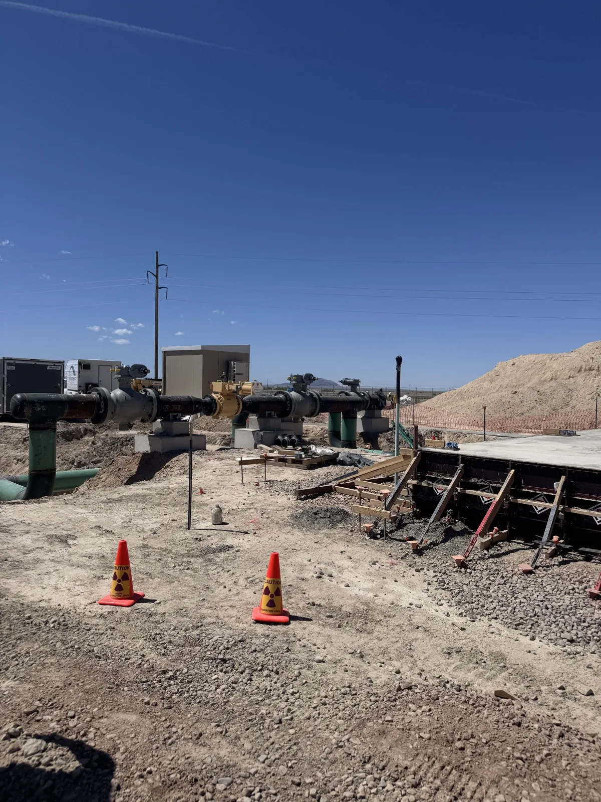Pressure-reducing and metering station taking shape, with safety cones marking the work area